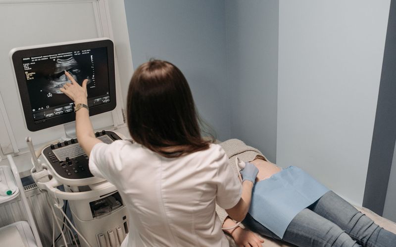 A doctor tracking follicles on an ultrasound scan