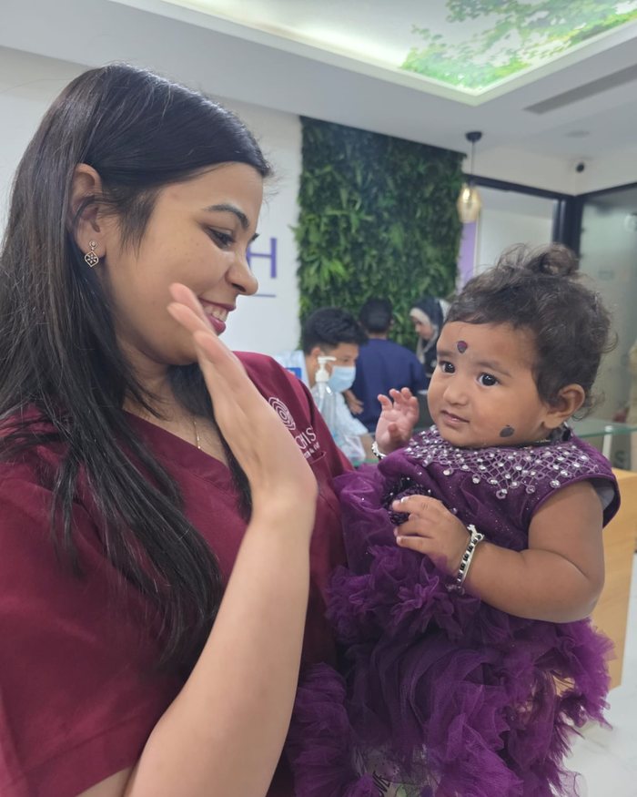 Dr. Ankita Gahlot sharing a joyful high-five with a toddler